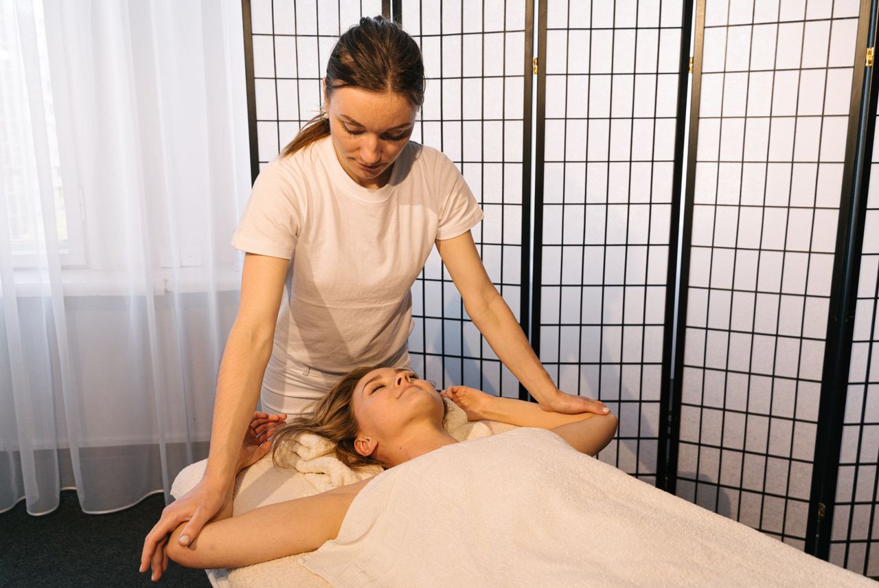 services-img A soothing spa therapy session with a massage therapist attending to a client indoors.