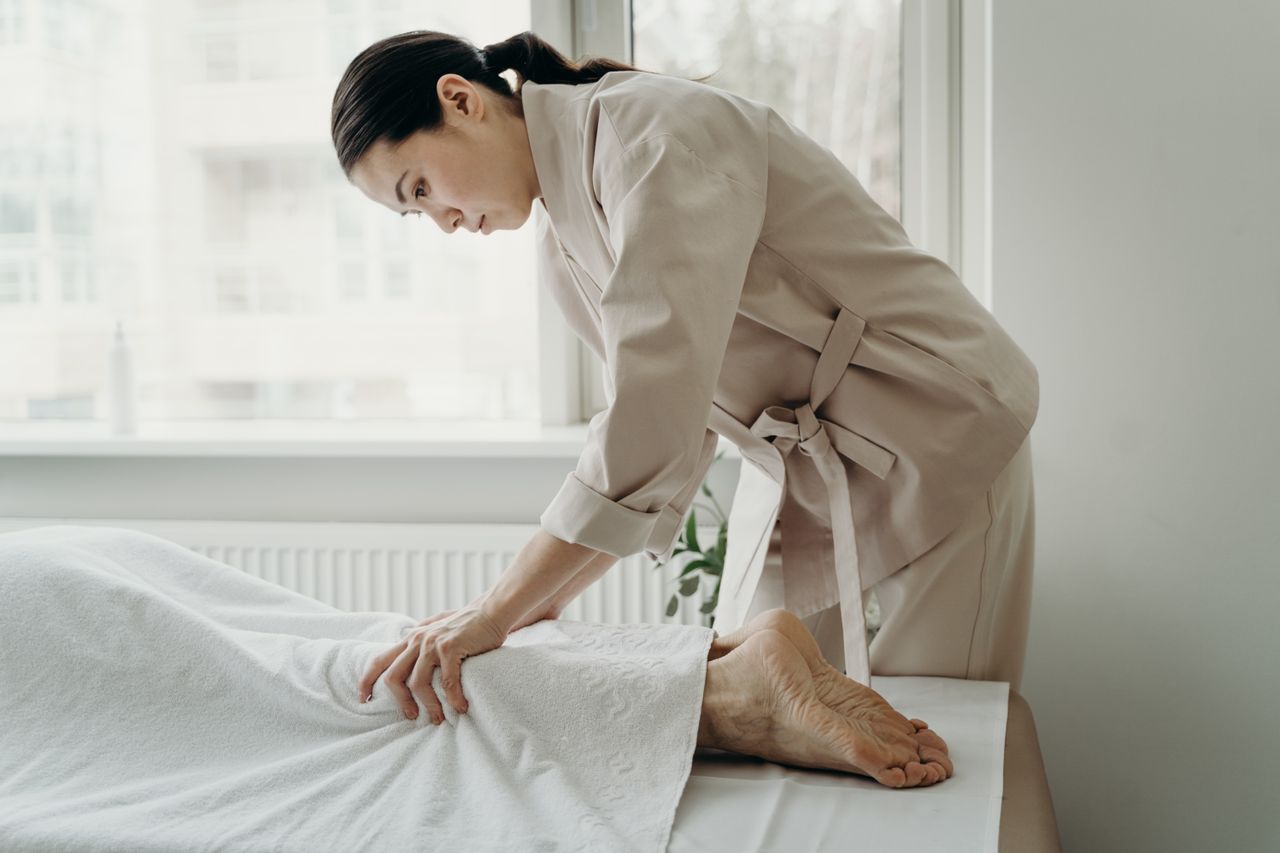 contact-img Asian female therapist providing a relaxing massage at a serene spa setting indoors.